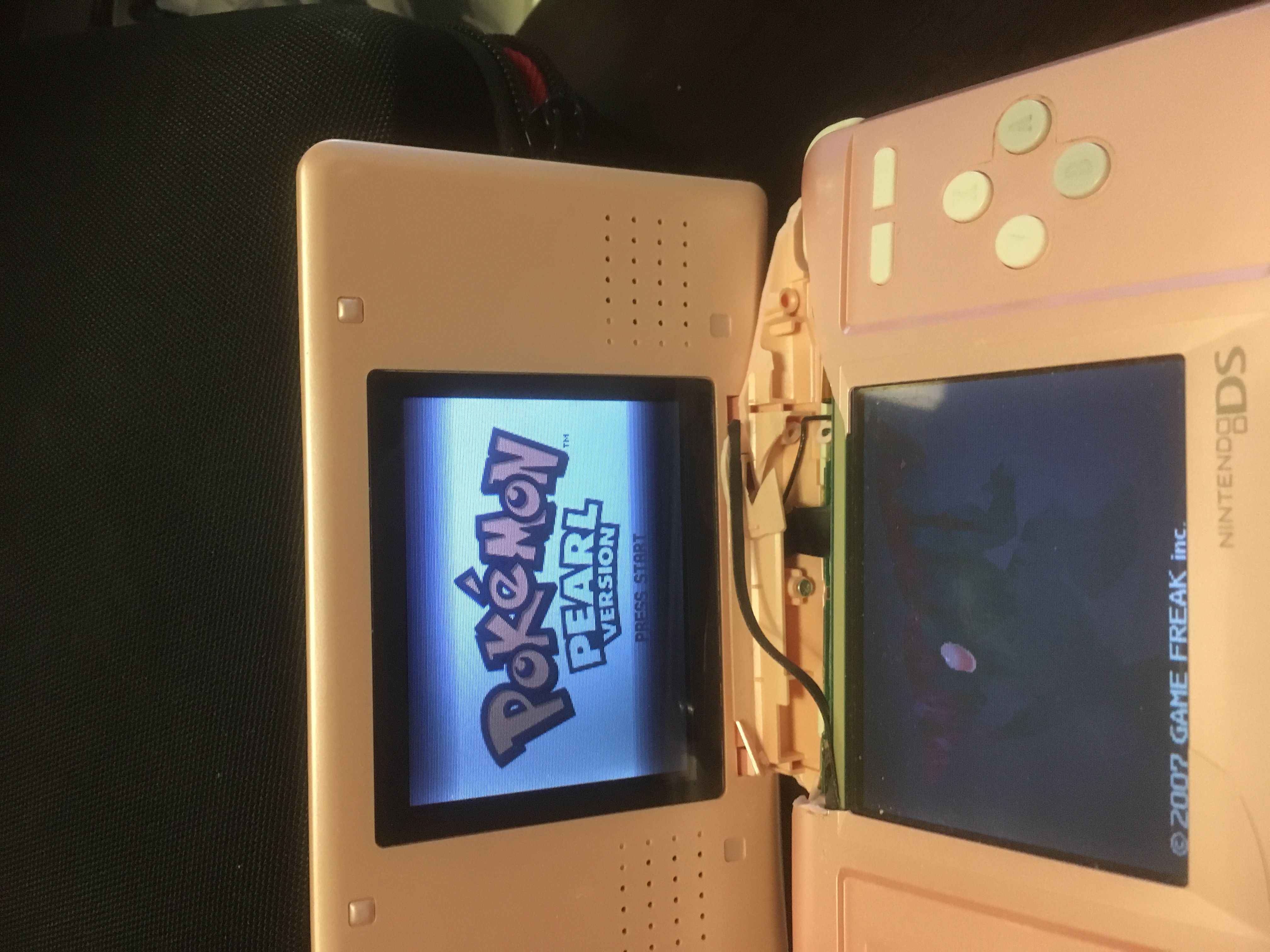 broken Nintendo DS showing a game's splash screen