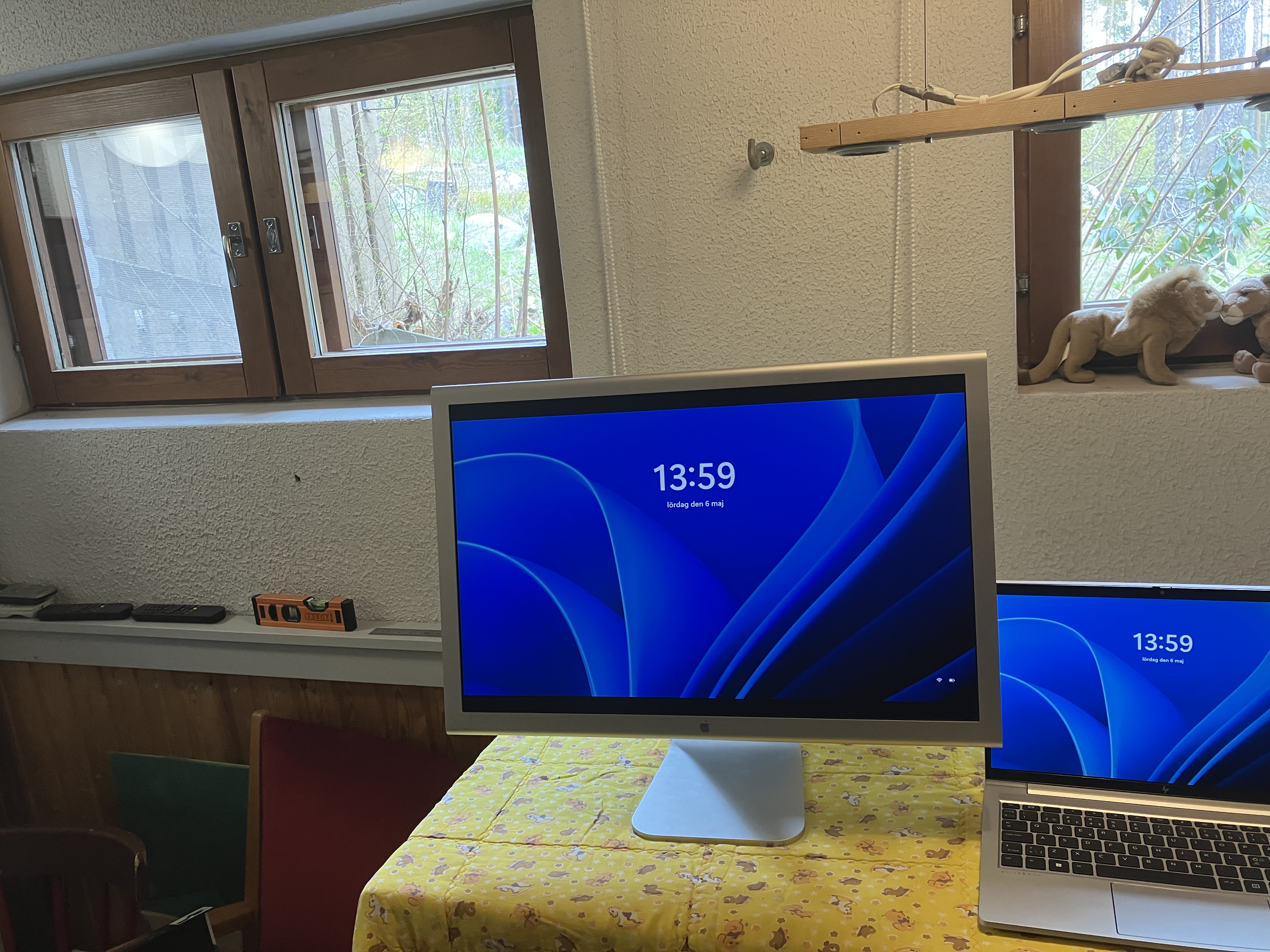 the monitor connected to a laptop, showing the Windows 11 lock screen